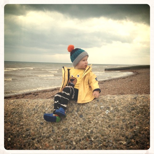 little-boy-sitting-on-the-beach