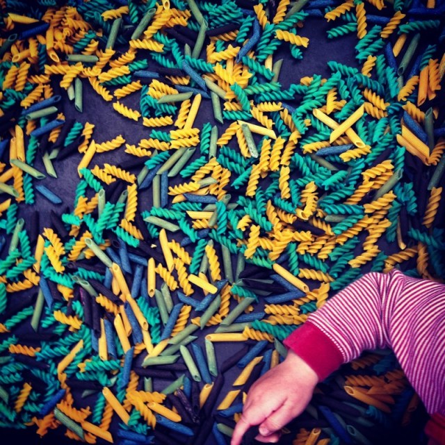 coloured-pasta-with-childs-hand