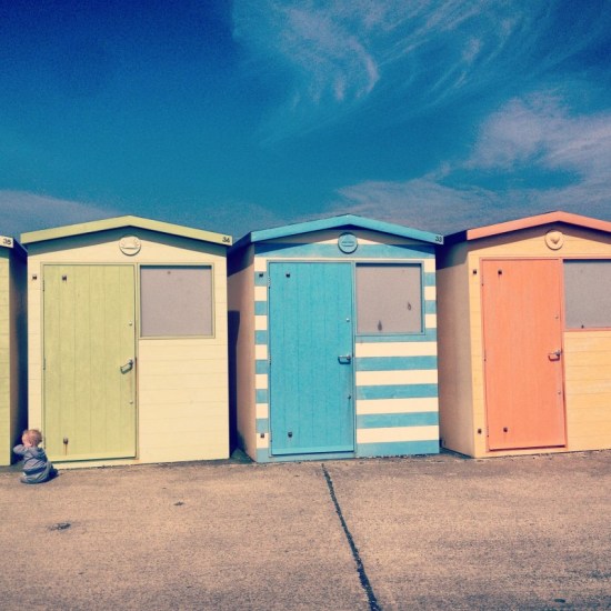 baby-sitting-in-front-of-beach-huts