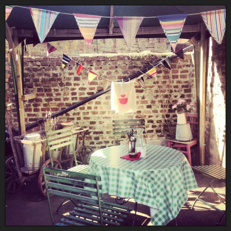 an-outside-cafe-table-with-bunting-above
